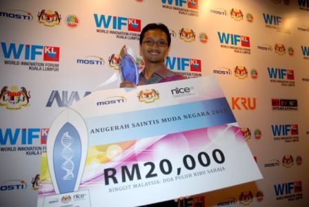 Exuberant Dr. Iqbal proudly flaunts the mock cheque of RM20,000 and plaque.